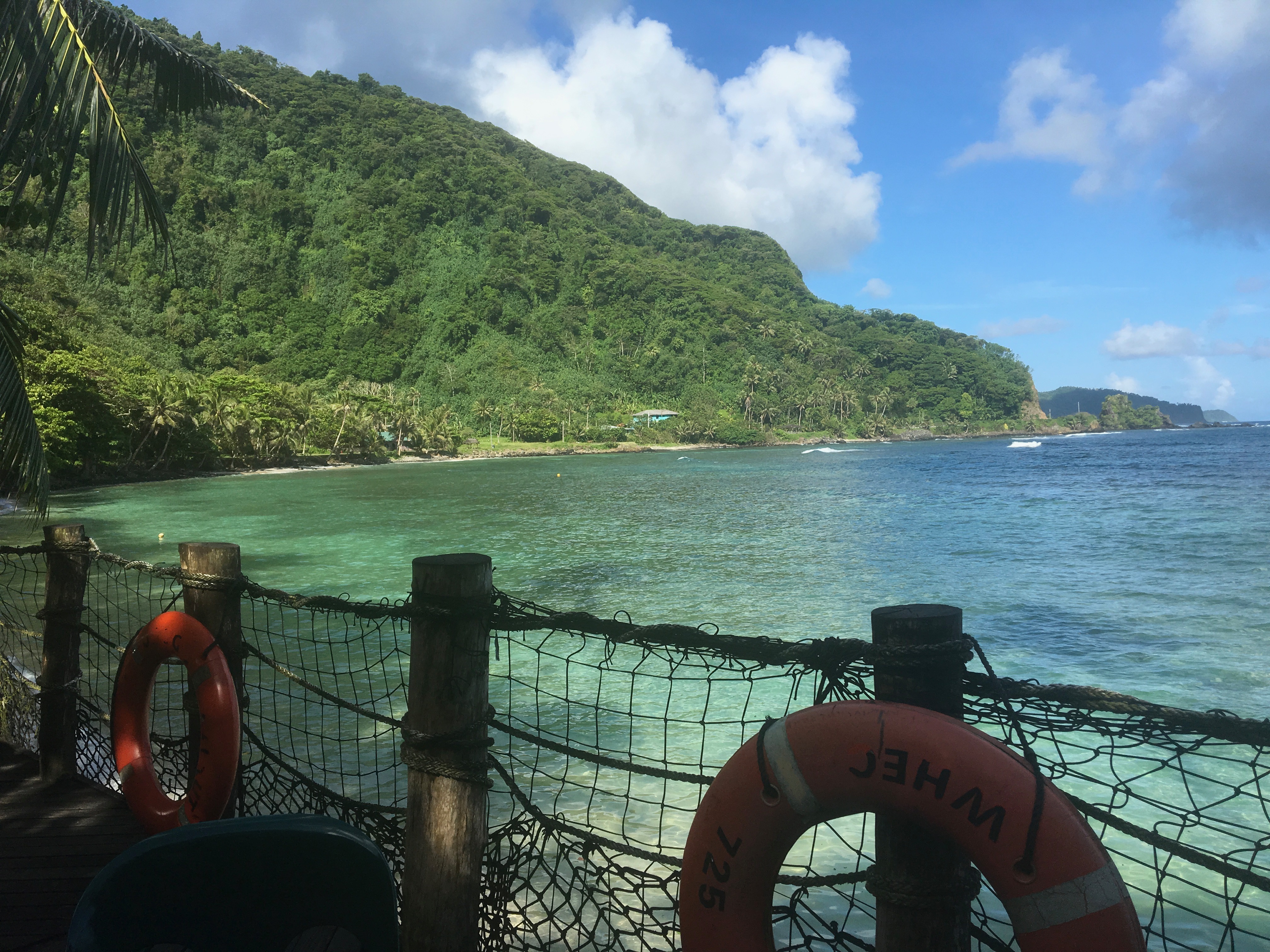Panoramic view of Alega Bay with turquoise waters and lush mountain
